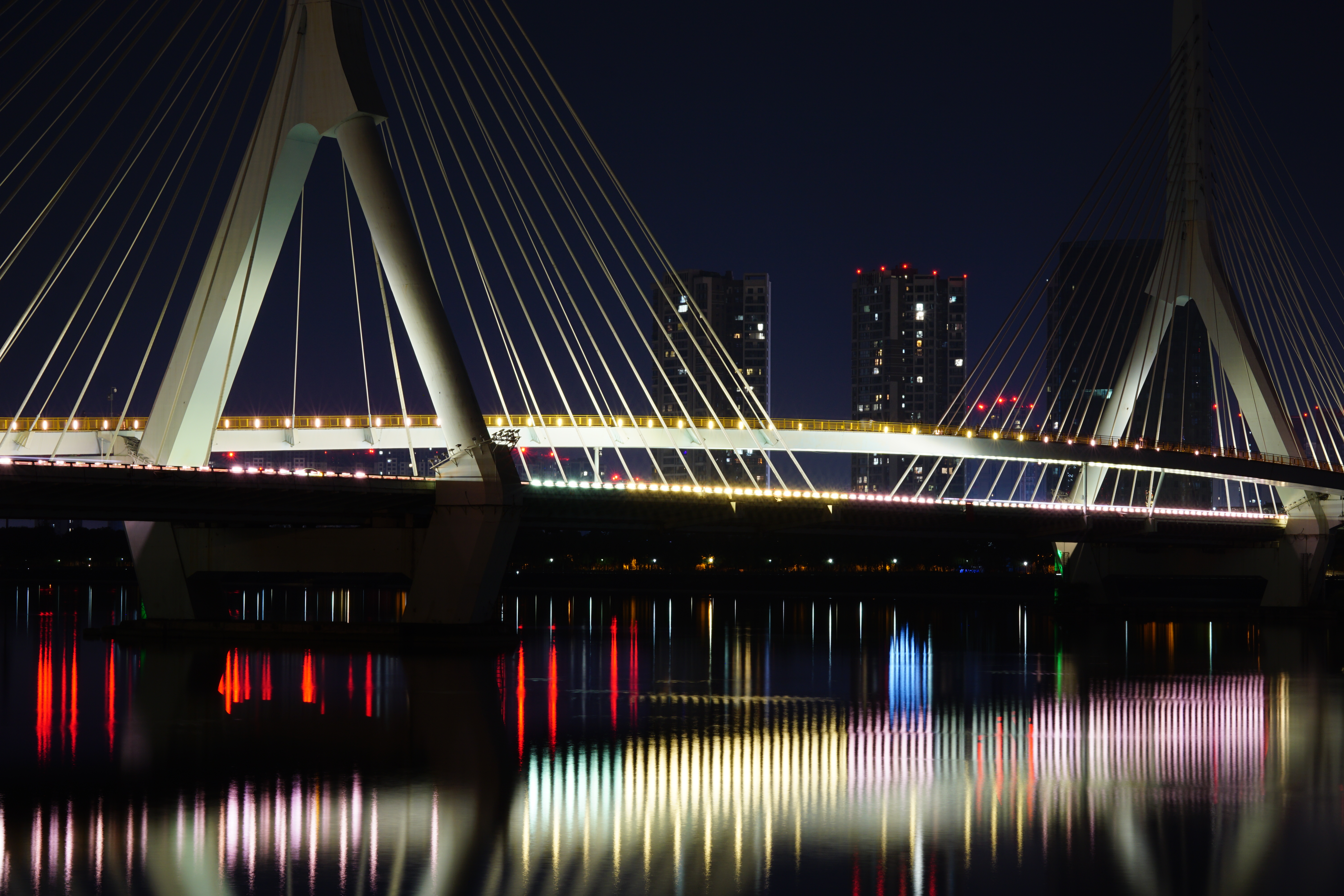  晚饭后徒步五公里适一号桥，未带脚架，夜景本无戏，直接把相机扔河堤栏杆上长曝光，光柱如旋律跃动。